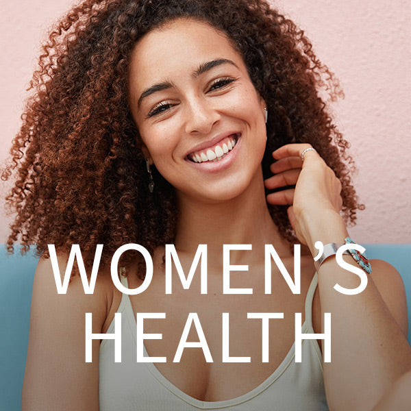 woman smiling with hands near neck women's health in white font