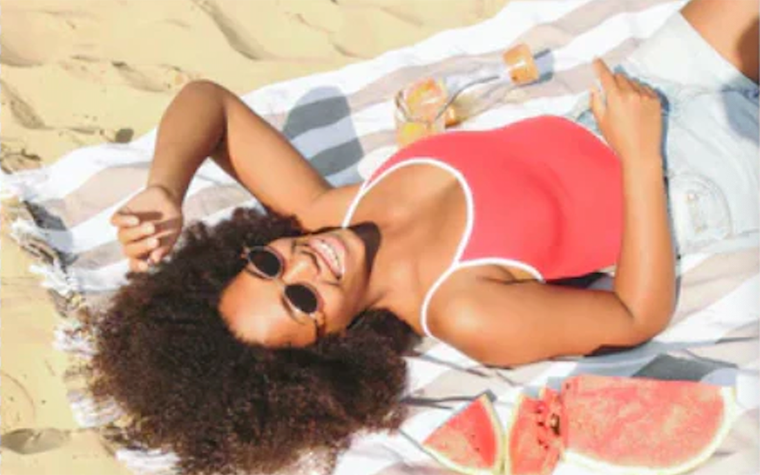 Woman at the beach celebrating life and starting a detox